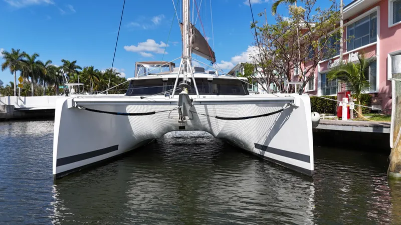 Slide: The Image of 2018 Fountaine Pajot Saona 47 catamaran docked by palm trees and buildings. - 7