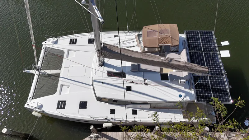 Slide: The Image of 2018 Fountaine Pajot Saona 47 catamaran with solar panels, docked on calm water. - 9