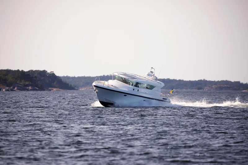 Slide: The Image of Delta Powerboats 400 SW 2025 cruising on open water, scenic coastal background. - 3