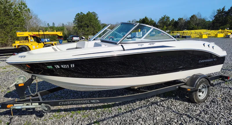 Slide: The Image of 2012 Chaparral 18 Sport H2O boat on trailer, parked on gravel lot. - 0