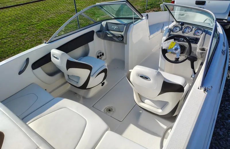 Slide: The Image of 2012 Chaparral 18 Sport H2O boat interior with white seating and dashboard. - 1