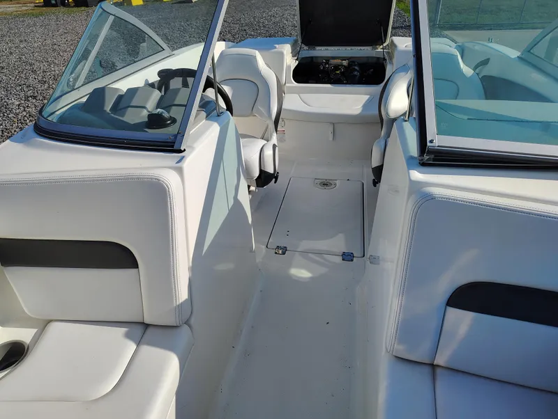 Slide: The Image of 2012 Chaparral 18 Sport H2O boat interior with white seating and open cockpit. - 10