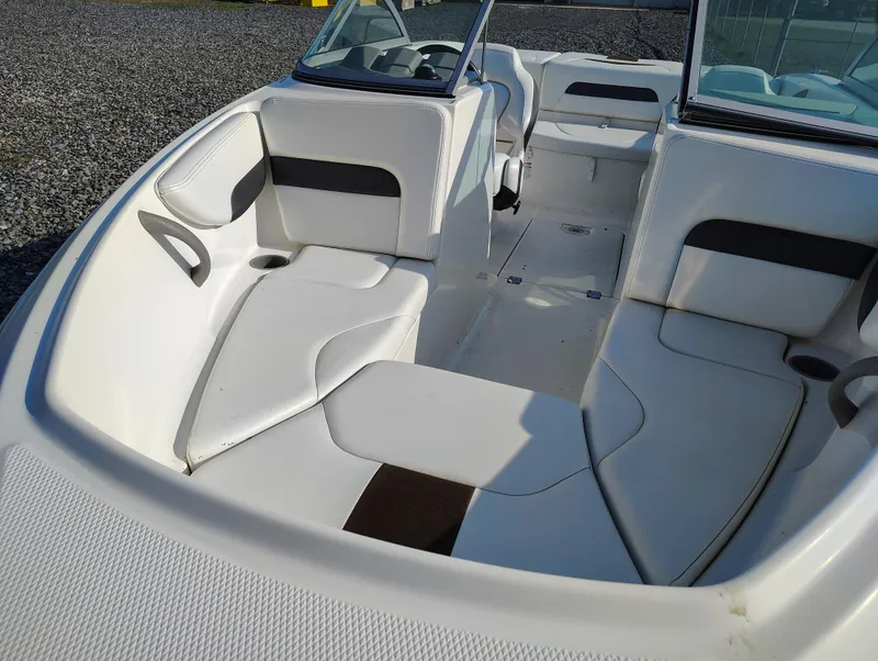 Slide: The Image of 2012 Chaparral 18 Sport H2O boat interior with white seating and open deck. - 11