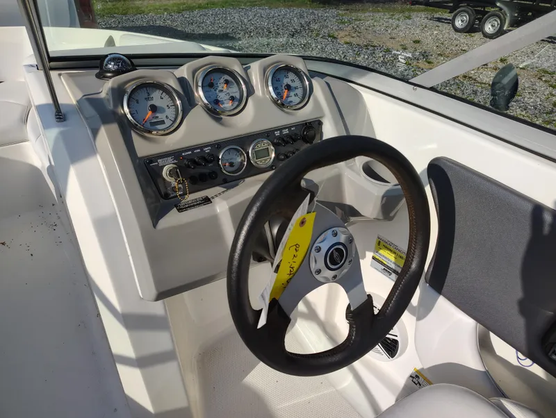 Slide: The Image of 2012 Chaparral 18 Sport H2O boat dashboard with steering wheel and gauges. - 12