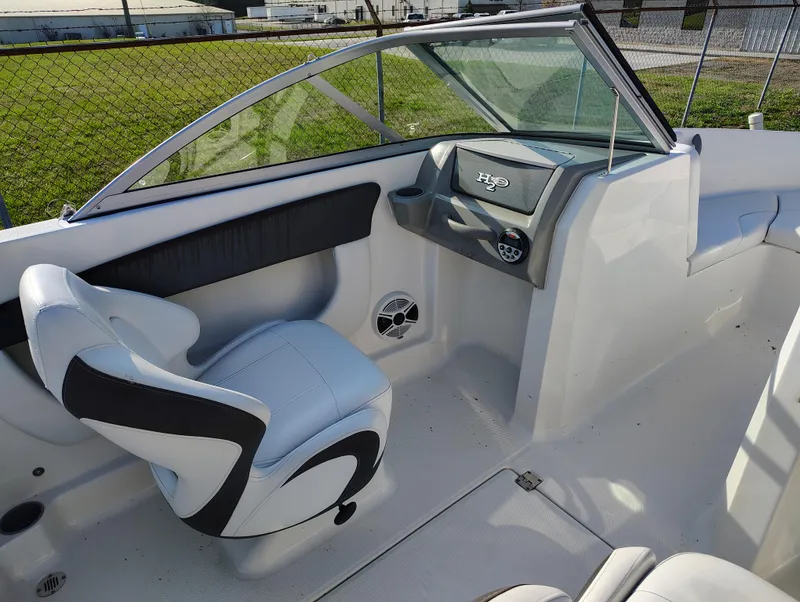 Slide: The Image of 2012 Chaparral 18 Sport H2O boat interior with sleek seating and modern dashboard. - 14