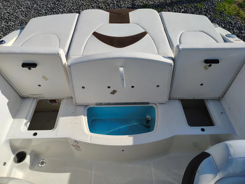 Slide: The Image of 2012 Chaparral 18 Sport H2O boat interior with storage compartments and seating. - 16
