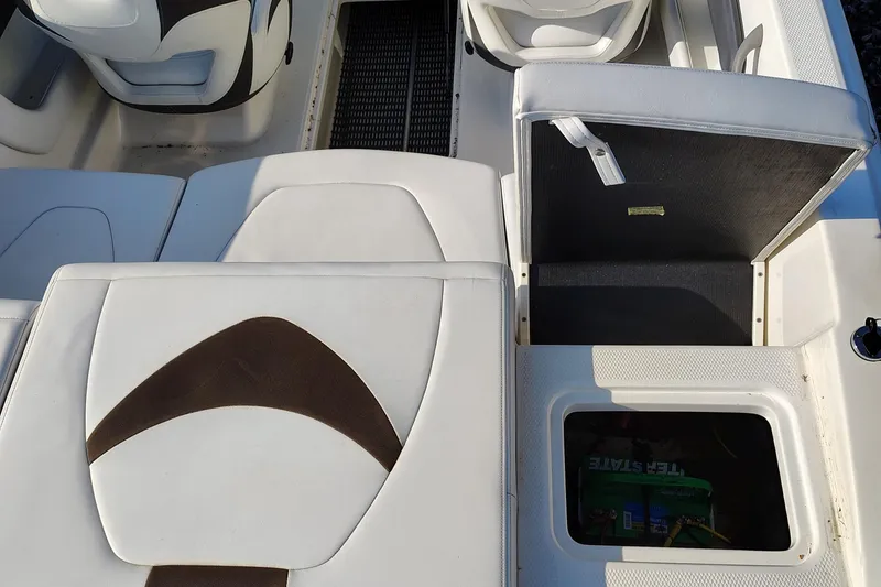 Slide: The Image of 2012 Chaparral 18 Sport H2O boat interior with open storage compartments. - 17