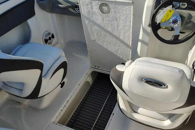 Slide: The Image of 2012 Chaparral 18 Sport H2O boat interior with white seating and steering wheel. - 18