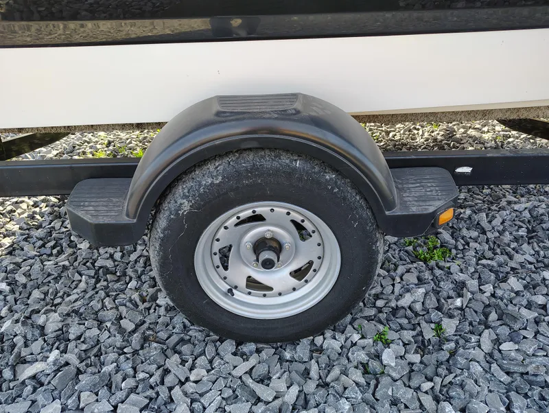 Slide: The Image of Trailer wheel of 2012 Chaparral 18 Sport H2O on gravel surface. - 20