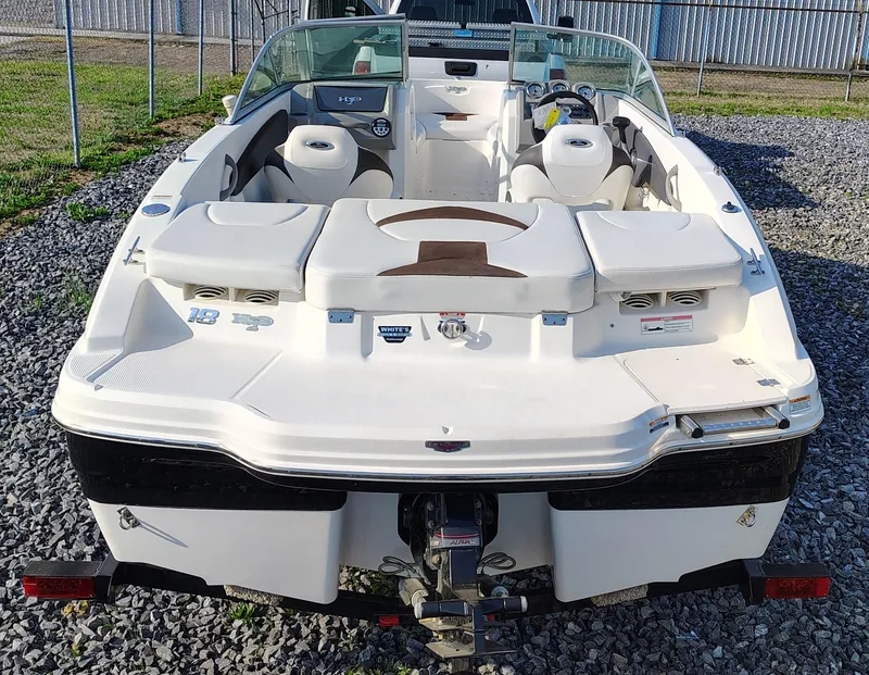 Slide: The Image of 2012 Chaparral 18 Sport H2O boat, rear view, on trailer, parked on gravel. - 6