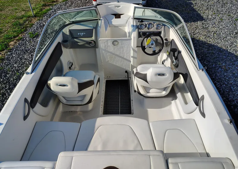 Slide: The Image of 2012 Chaparral 18 Sport H2O boat interior with seating and steering wheel. - 7