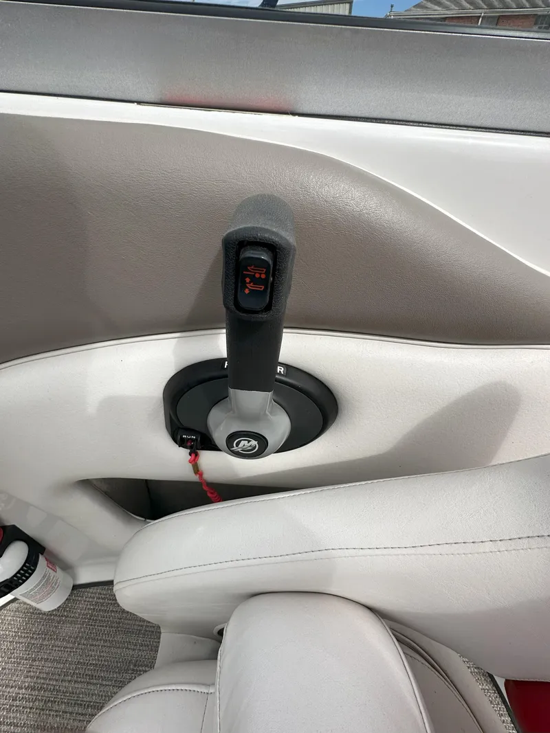 Slide: The Image of 2003 Crownline 230 boat throttle control in a sleek interior setting. - 10