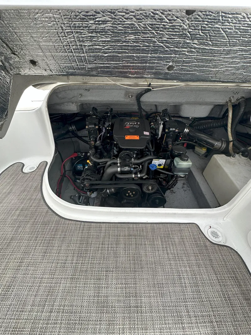 Slide: The Image of 2003 Crownline 230 boat engine compartment with visible mechanical components. - 12