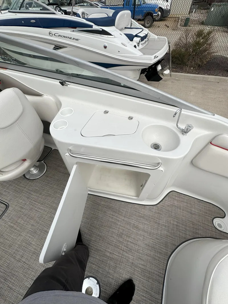 Slide: The Image of 2003 Crownline 230 boat interior with sink and storage compartment. - 9