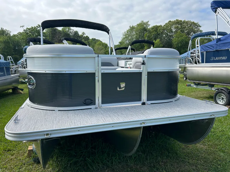 Slide: The Image of 2023 Landau Island Breeze 232 Cruise pontoon boat on grass, featuring sleek design and spacious seating. - 6