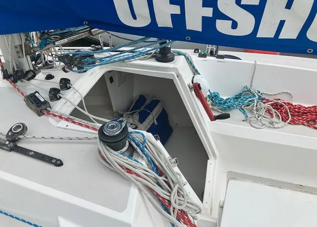 Slide: The Image of Sailboat cockpit with ropes and winches, Colgate Sloop 2015 model, featuring "OFFSHORE" sail. - 3