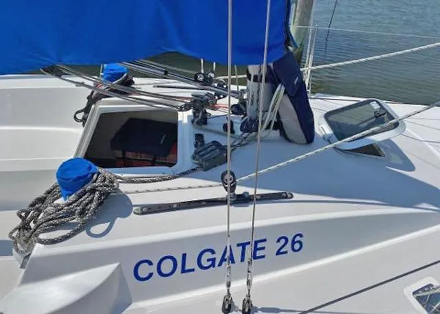 Slide: The Image of Sailboat Colgate 26, 2015 model, with blue sail cover and ropes on deck. - 4