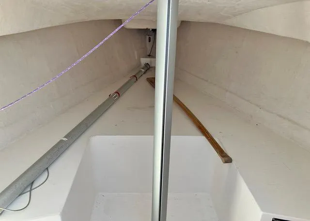 Slide: The Image of Interior view of a 2015 Colgate Sloop sailboat, showing mast and storage area. - 8