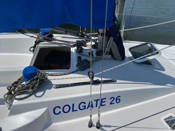 Slide: The Image of Sailboat Colgate 26, 2007 model, docked with visible ropes and equipment. - 3