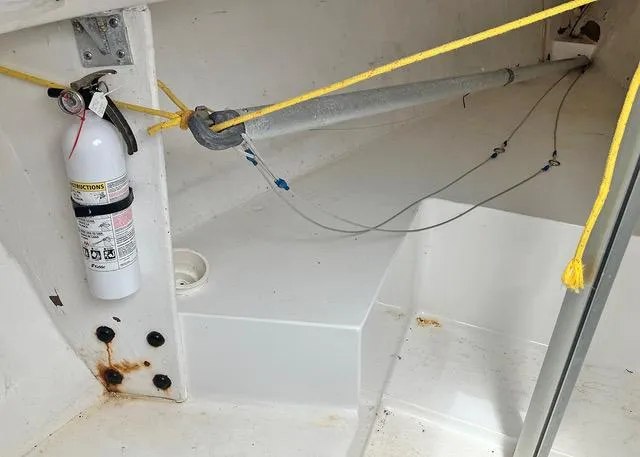 Slide: The Image of 2007 Colgate Sloop interior with fire extinguisher and rigging components. - 4