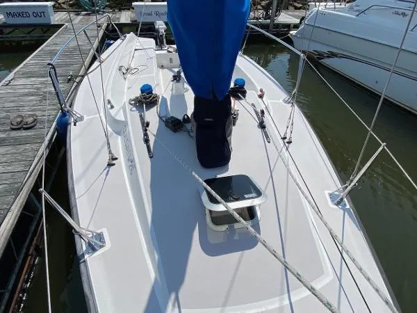 Slide: The Image of 2007 Colgate Sloop sailboat docked at marina, featuring sleek deck design. - 5