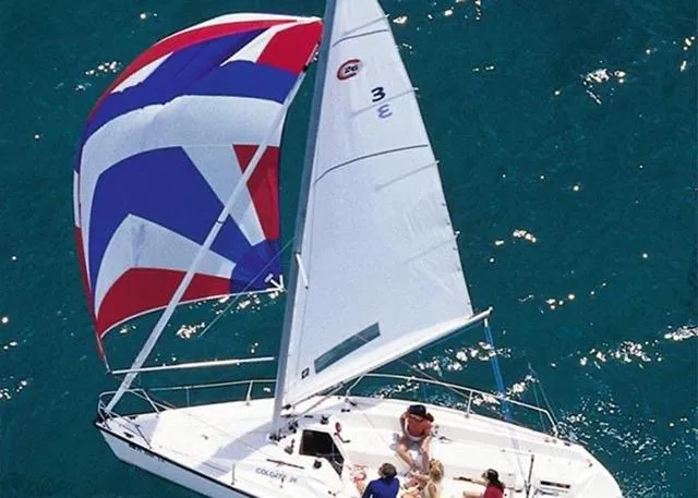Slide: The Image of Sailboat Colgate Sloop 2007 with colorful spinnaker on clear blue water. - 7