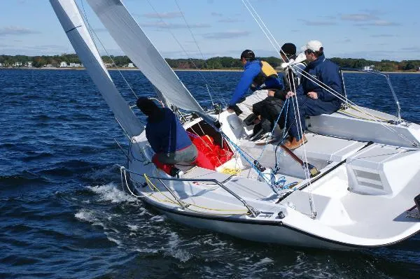 Slide: The Image of Sailors navigating a 2007 Colgate Sloop on open water, showcasing teamwork and skill. - 9