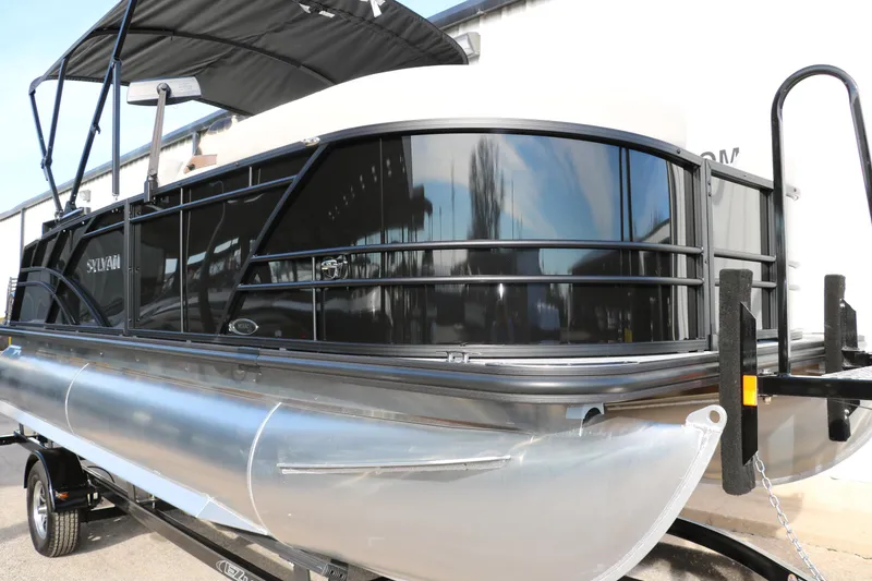 Slide: The Image of 2025 Sylvan 820 CLZ DH Premium Pontoon with sleek black design and canopy. - 4
