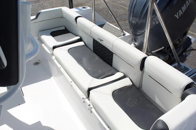 Slide: The Image of 2025 Tidewater 210 LXF boat interior with cushioned seating and Yamaha engine. - 10
