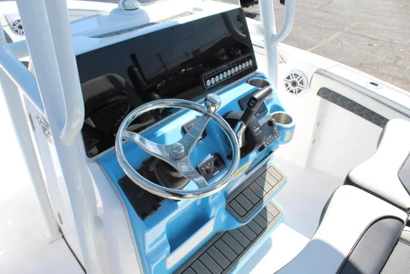 Slide: The Image of 2025 Tidewater 210 LXF boat console with steering wheel and controls. - 12