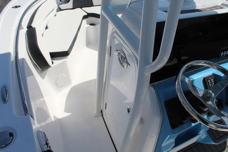 Slide: The Image of 2025 Tidewater 210 LXF boat interior with steering wheel and seating area. - 15