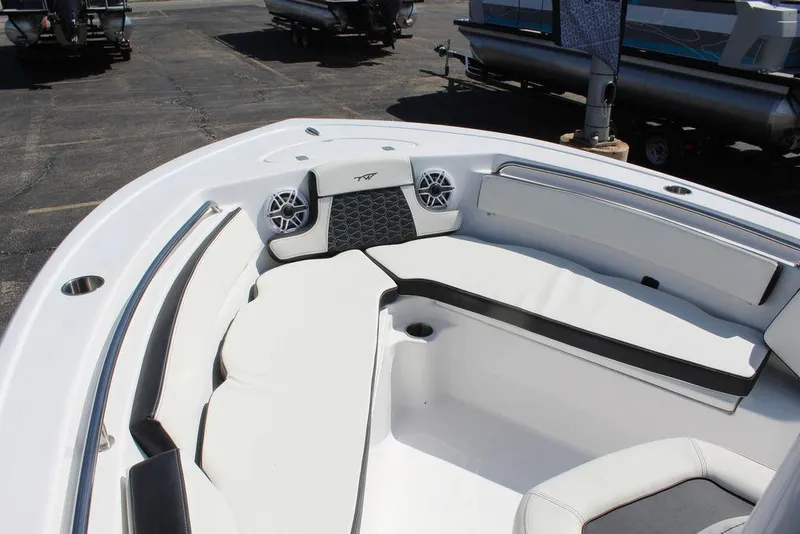 Slide: The Image of 2025 Tidewater 210 LXF boat interior with white seating and speakers. - 16