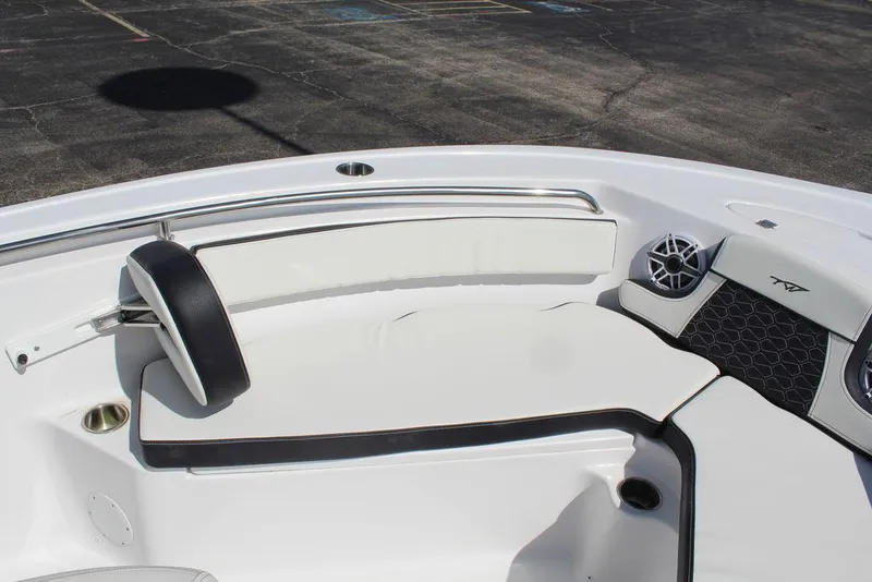 Slide: The Image of 2025 Tidewater 210 LXF boat interior with white seating and speaker system. - 17