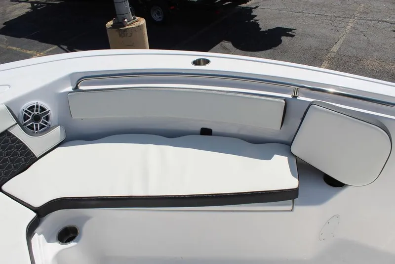 Slide: The Image of 2025 Tidewater 210 LXF boat interior with cushioned seating and speaker. - 21