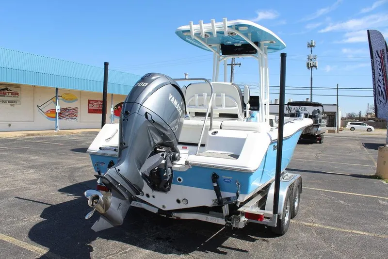 Slide: The Image of 2025 Tidewater 210 LXF boat with Yamaha engine on trailer, parked outdoors. - 4