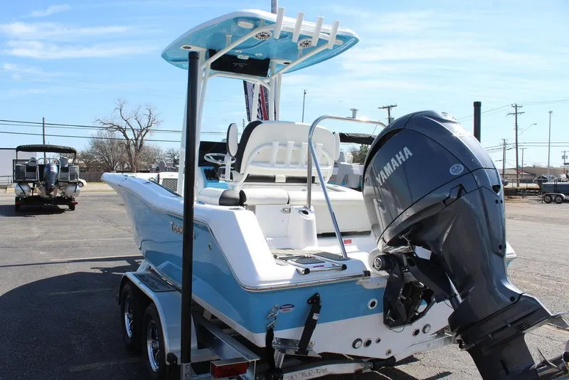 Slide: The Image of 2025 Tidewater 210 LXF boat with Yamaha engine, parked on a trailer in a sunny lot. - 7
