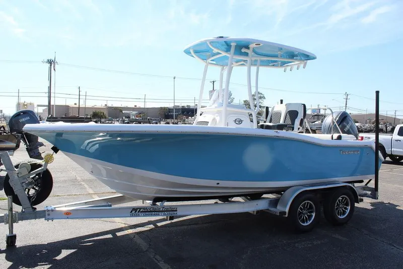 Slide: The Image of 2025 Tidewater 210 LXF boat on trailer, blue hull, parked outdoors. - 8