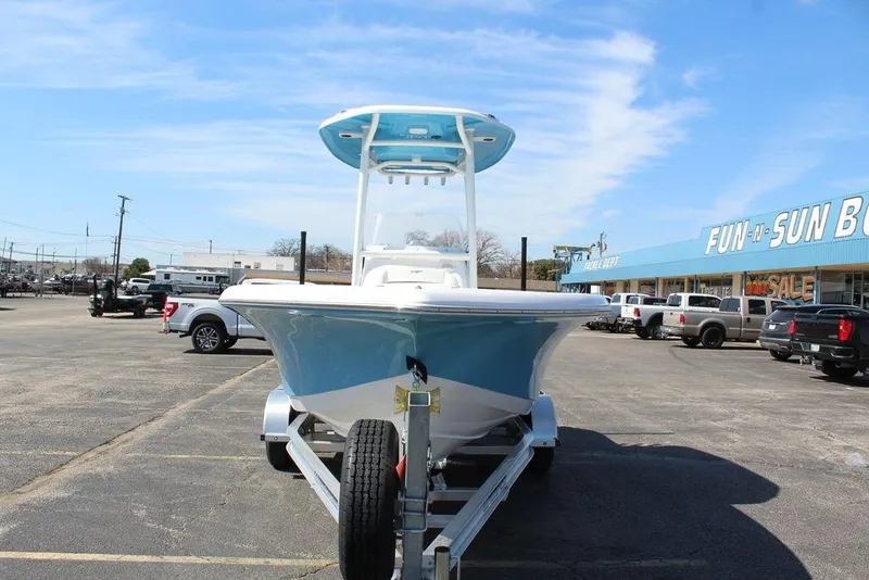 Slide: The Image of 2025 Tidewater 210 LXF boat on trailer in parking lot, blue sky background. - 9