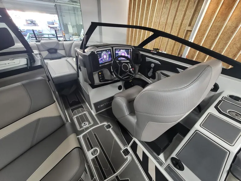 Slide: The Image of 2021 Centurion Ri245 boat interior with modern dashboard and luxurious seating. - 12