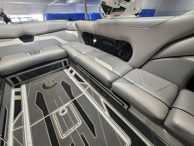 Slide: The Image of 2021 Centurion Ri245 boat interior with gray seating and stylish flooring design. - 14