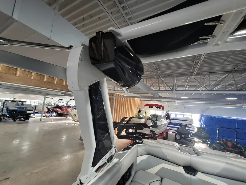 Slide: The Image of 2021 Centurion Ri245 boat interior with speaker and seating in showroom. - 16