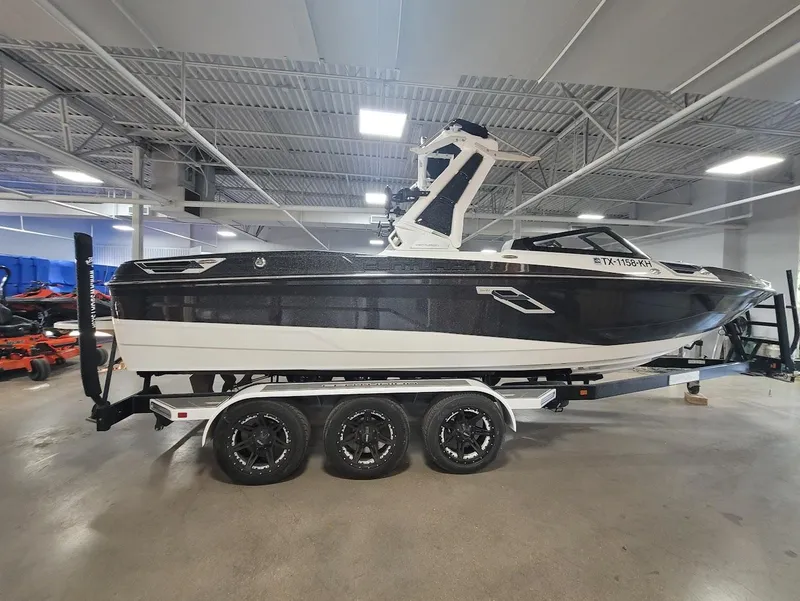 Slide: The Image of 2021 Centurion Ri245 boat on a trailer in a showroom. - 5