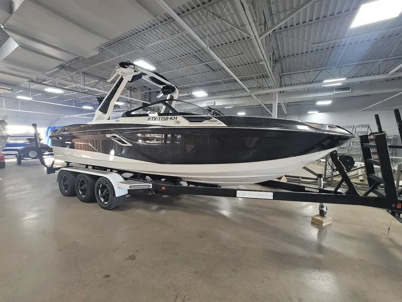 Slide: The Image of 2021 Centurion Ri245 boat on trailer in indoor showroom. - 6