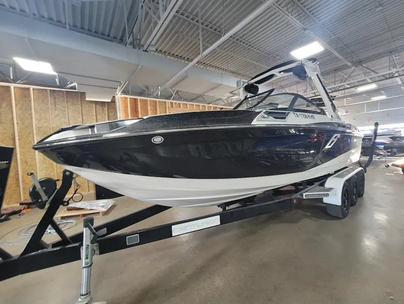Slide: The Image of 2021 Centurion Ri245 boat on trailer in indoor showroom. - 8