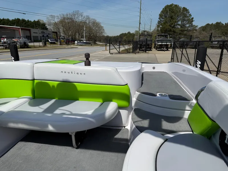 Slide: The Image of 2007 Nautique Air SV-211 boat interior with green and white seating, parked outdoors. - 15