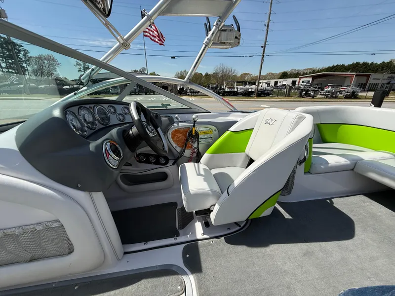 Slide: The Image of 2007 Nautique Air SV-211 boat interior with green accents and steering wheel. - 16