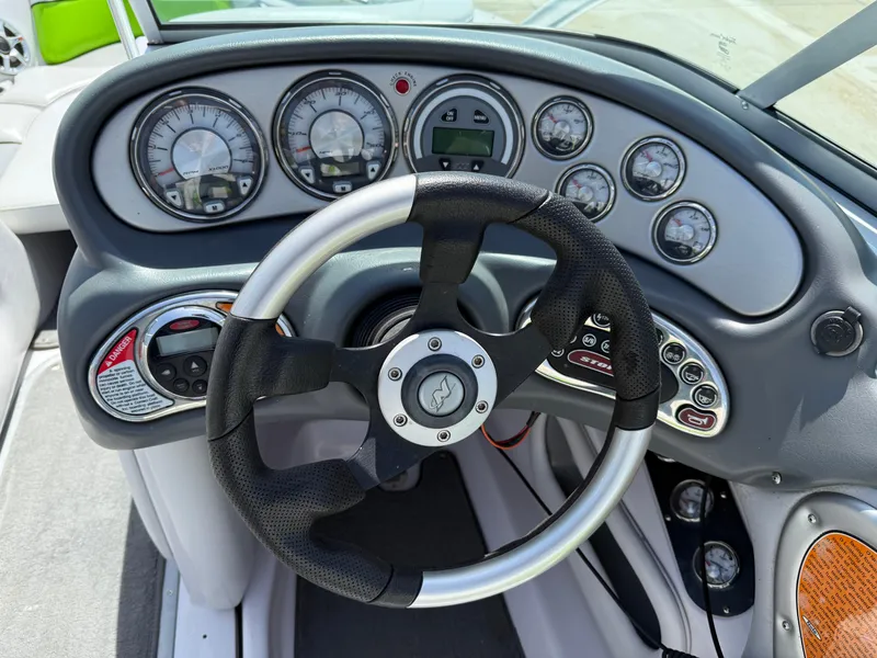 Slide: The Image of 2007 Nautique Air SV-211 dashboard with steering wheel and instrument gauges. - 19