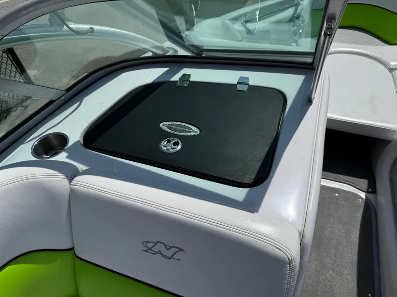 Slide: The Image of 2007 Nautique Air SV-211 boat interior with open storage compartment and cup holder. - 20