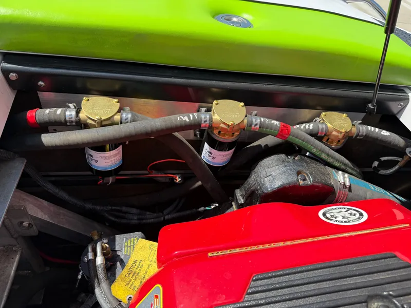 Slide: The Image of Engine components of a 2007 Nautique Air SV-211 boat, featuring hoses and filters. - 24