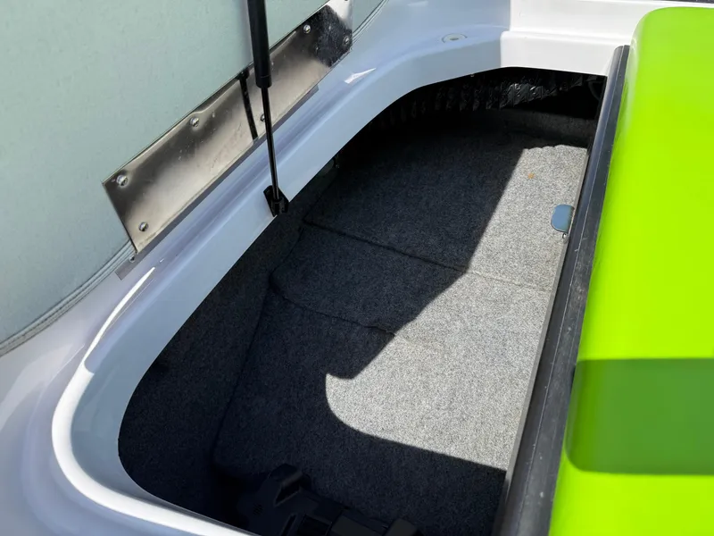 Slide: The Image of Storage compartment of 2007 Nautique Air SV-211 boat with green accents. - 25